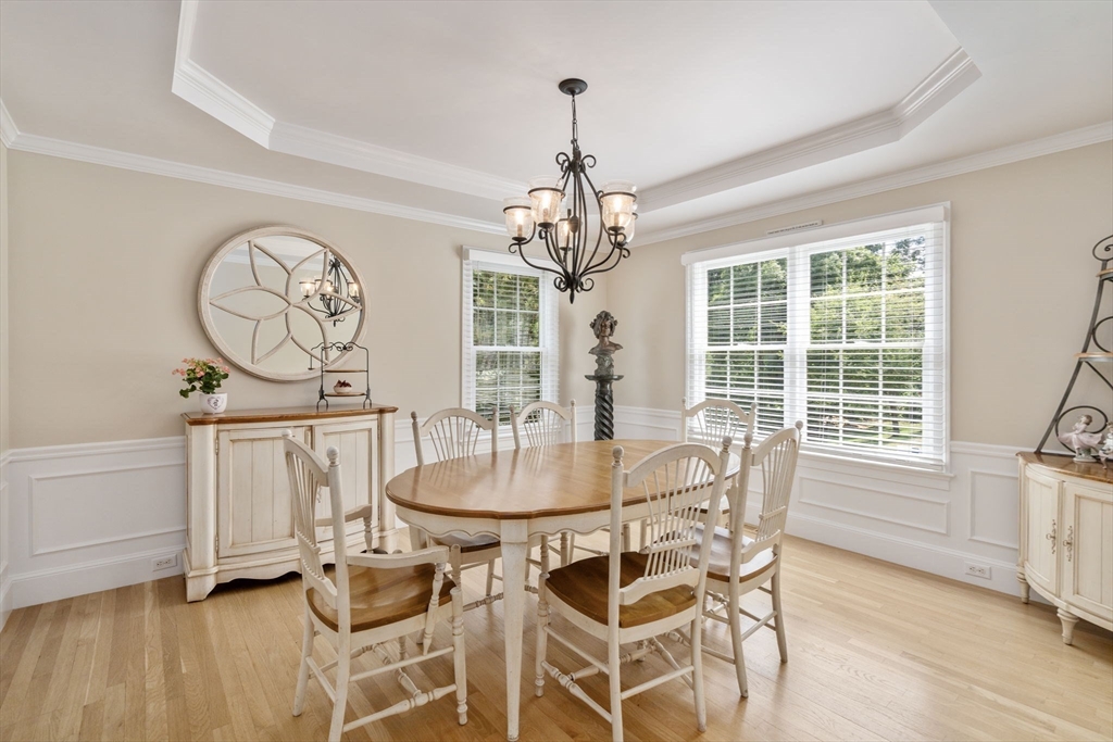 63 High Street Shrewsbury, MA 01545 - Photo 17 of 40 a dining room with chandelier and wooden floor