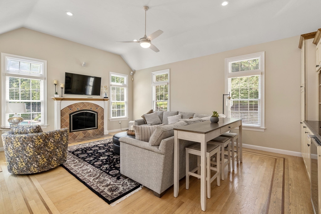 63 High Street Shrewsbury, MA 01545 - Photo 19 of 40 a living room with furniture a fireplace and a flat screen tv