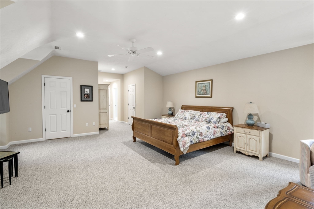 63 High Street Shrewsbury, MA 01545 - Photo 27 of 40 a spacious bedroom with a bed and a lamp
