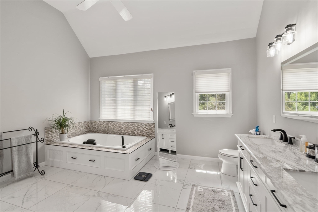 63 High Street Shrewsbury, MA 01545 - Photo 29 of 40 a spacious bathroom with a tub sink and mirror