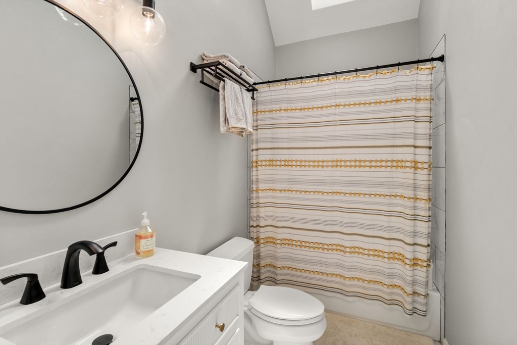 63 High Street Shrewsbury, MA 01545 - Photo 32 of 40 a bathroom with a sink and a mirror