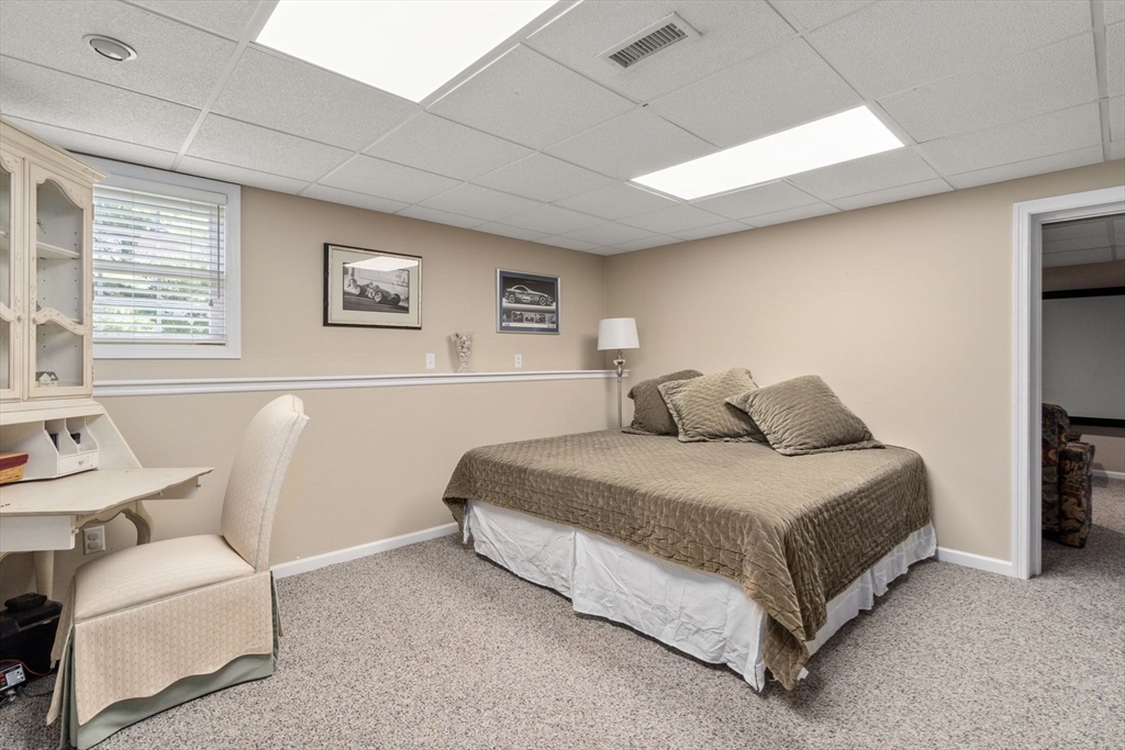 63 High Street Shrewsbury, MA 01545 - Photo 35 of 40 a spacious bedroom with a bed and a couch