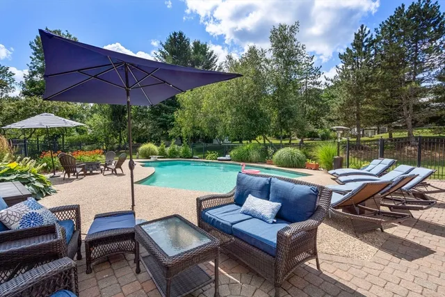 a view of yard with seating area and umbrella
