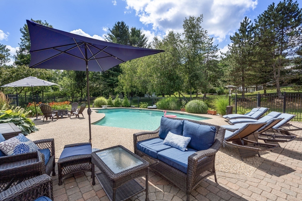 63 High Street Shrewsbury, MA 01545 - Photo 6 of 40 a view of yard with seating area and umbrella