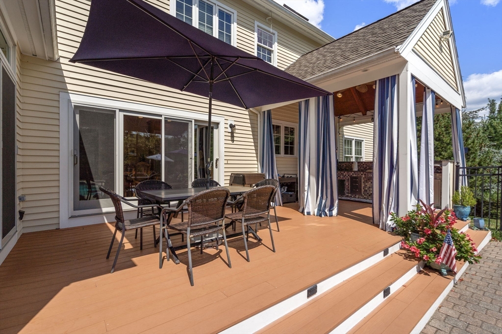 63 High Street Shrewsbury, MA 01545 - Photo 7 of 40 a view of a patio with table and chairs and potted plants