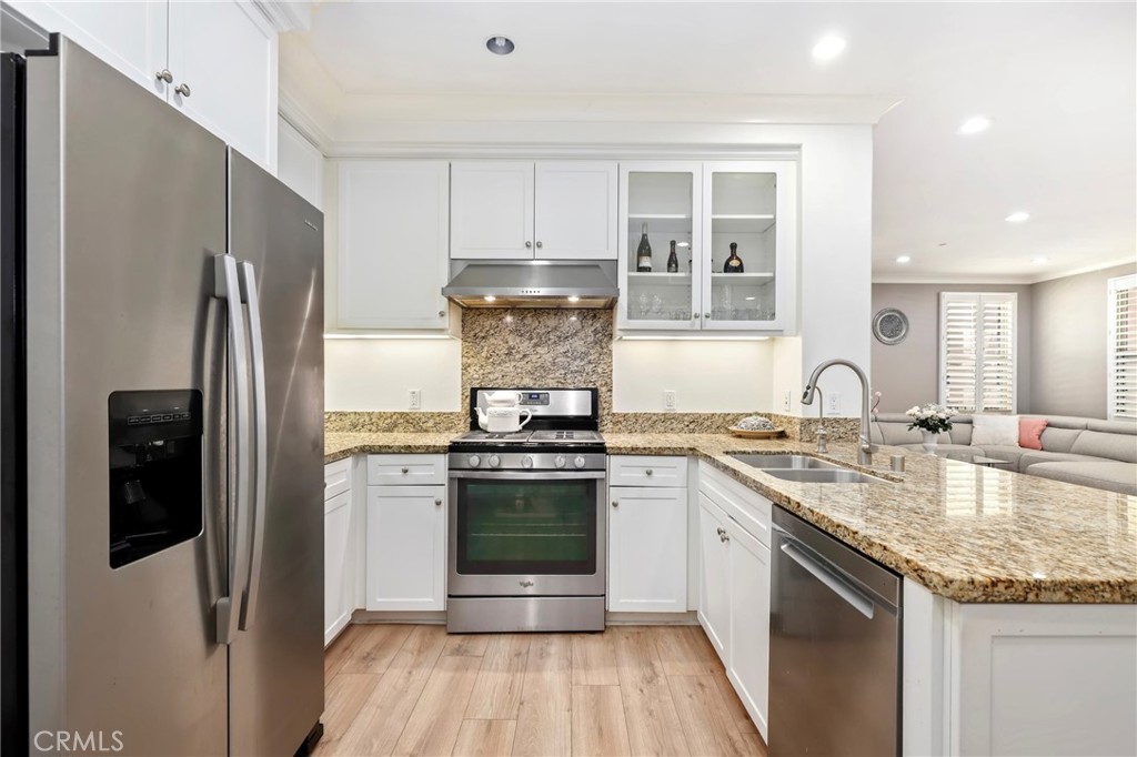 59 Kempton Irvine, CA 92620 - Photo 11 of 29 a kitchen with stainless steel appliances granite countertop a refrigerator sink and stove