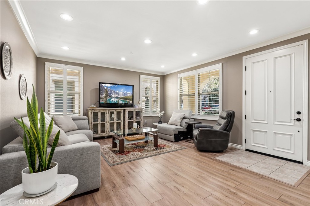59 Kempton Irvine, CA 92620 - Photo 5 of 29 a living room with furniture a potted plant and a wooden floor