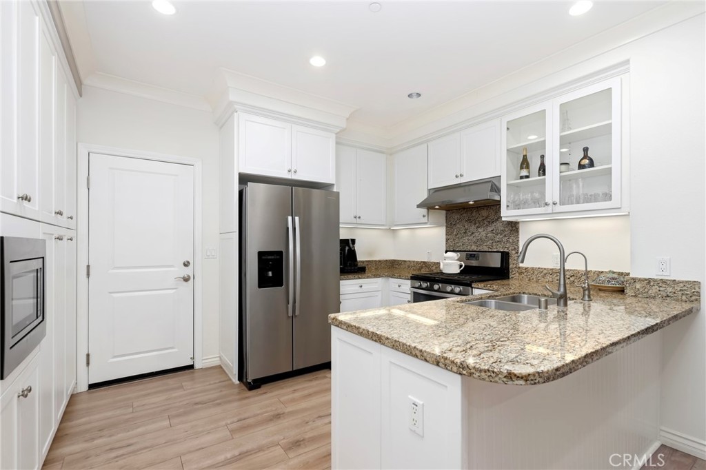 59 Kempton Irvine, CA 92620 - Photo 9 of 29 a kitchen with granite countertop a sink stove and refrigerator