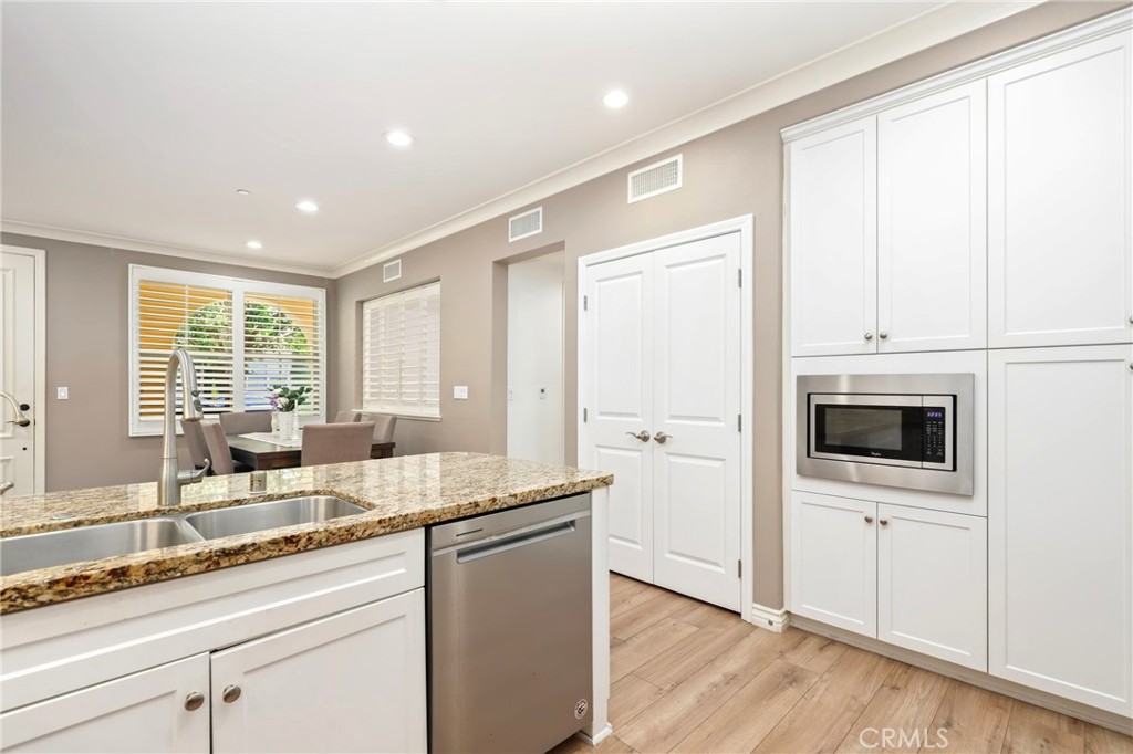 59 Kempton Irvine, CA 92620 - Photo 10 of 29 a kitchen with granite countertop a sink and a stove top oven