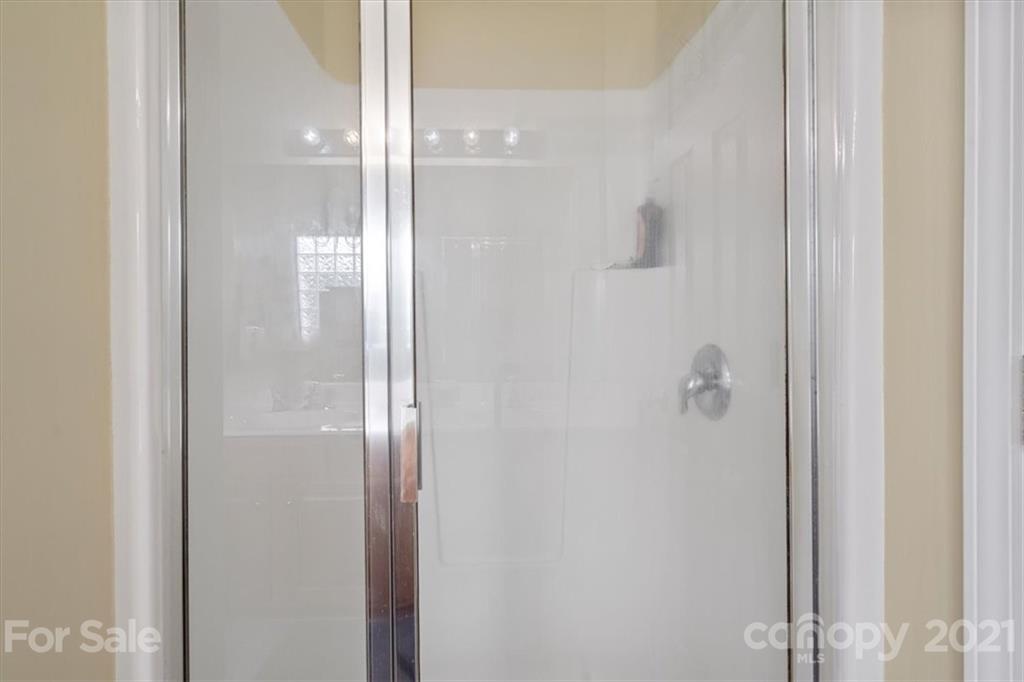 6115 Morning Mist End Fort Mill, SC 29708 - Photo 22 of 36 a bathroom with a glass shower door