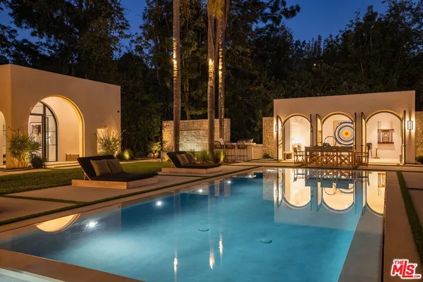 a view of swimming pool with outdoor seating and living room