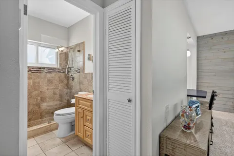 a bathroom with a toilet and a shower