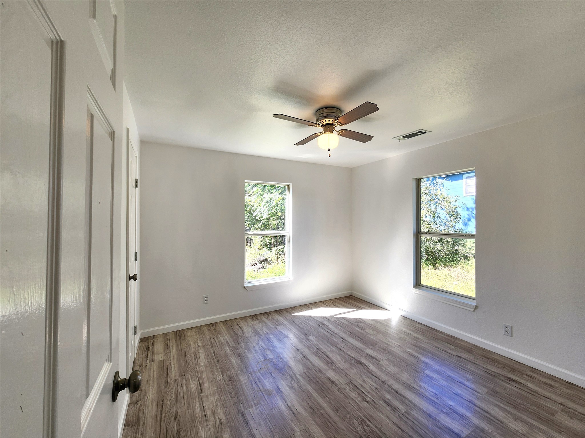 2706 Berry Street, Unit B Houston, TX 77004 - Photo 8 of 10 a view of an empty room with a window and wooden floor