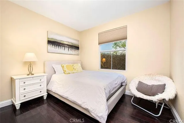 a bedroom with a bed and a chair