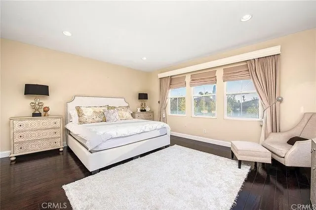 a bedroom with a bed and large window