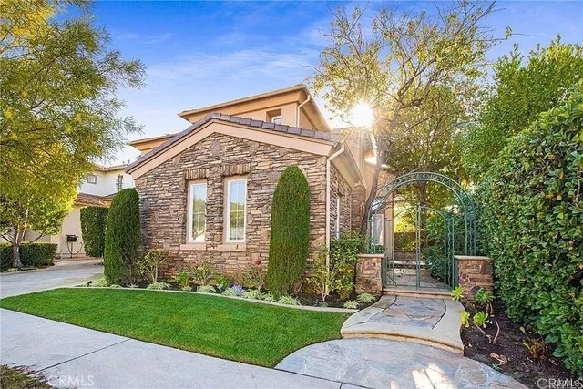 a front view of a house with a garden