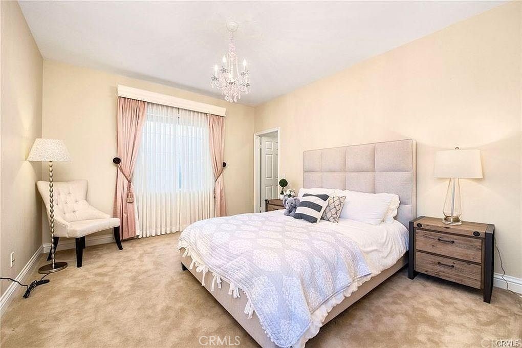32 Walnut Creek Irvine, CA 92602 - Photo 21 of 24 a bedroom with bed and a chandelier
