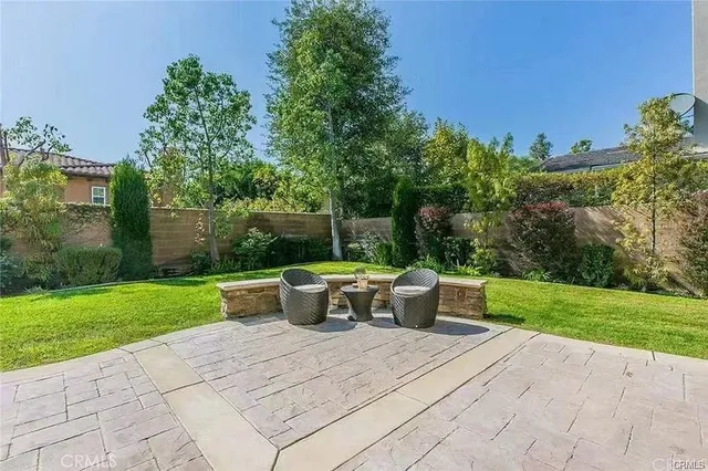 a view of backyard with outdoor seating and green space