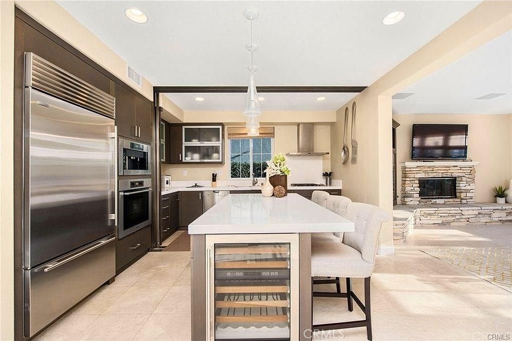 32 Walnut Creek Irvine, CA 92602 - Photo 7 of 24 a kitchen with kitchen island a counter top stainless steel appliances and cabinets