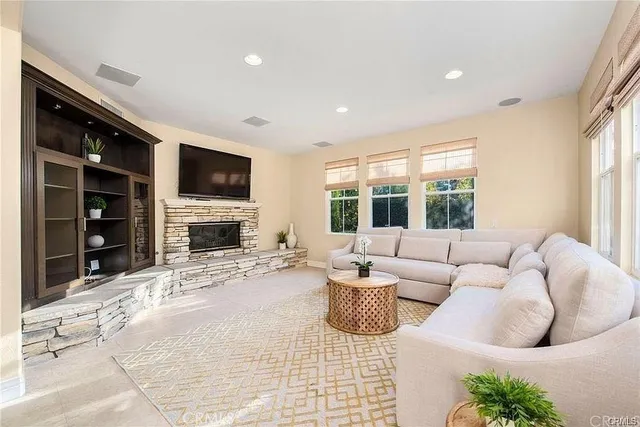 a living room with fireplace furniture and a flat screen tv
