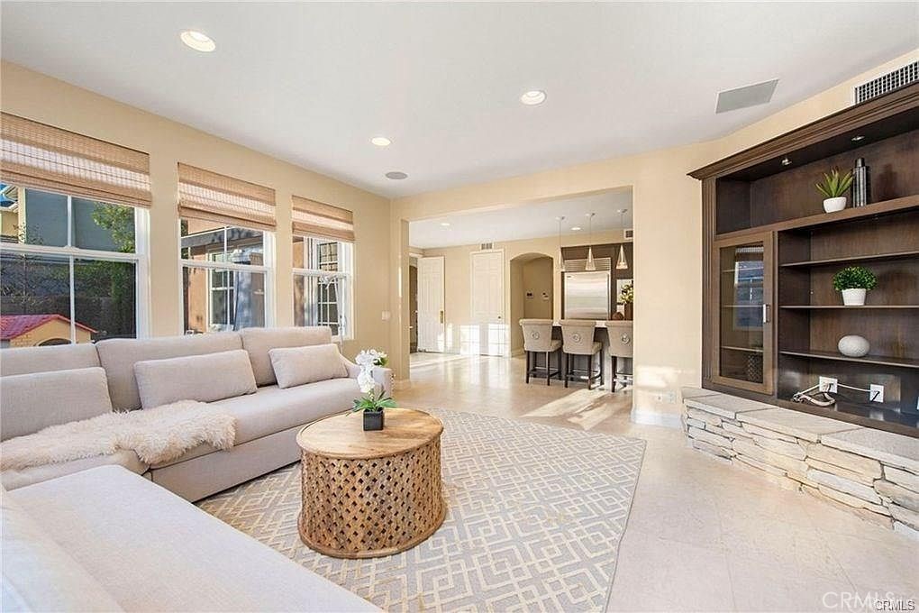 32 Walnut Creek Irvine, CA 92602 - Photo 9 of 24 a living room with furniture and a flat screen tv