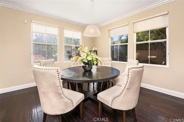 a dining room with furniture a window and wooden floor