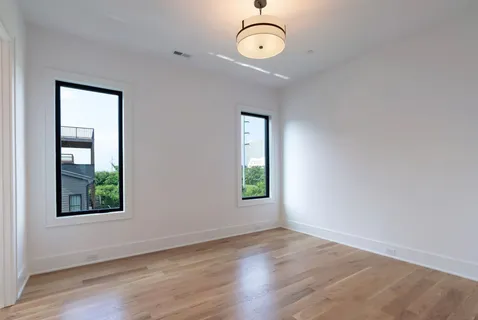 a front view of a residential apartment building with a yard