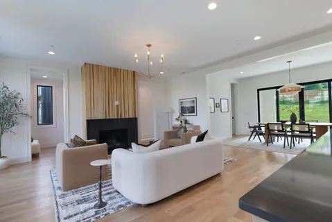 a dining room with furniture window and wooden floor