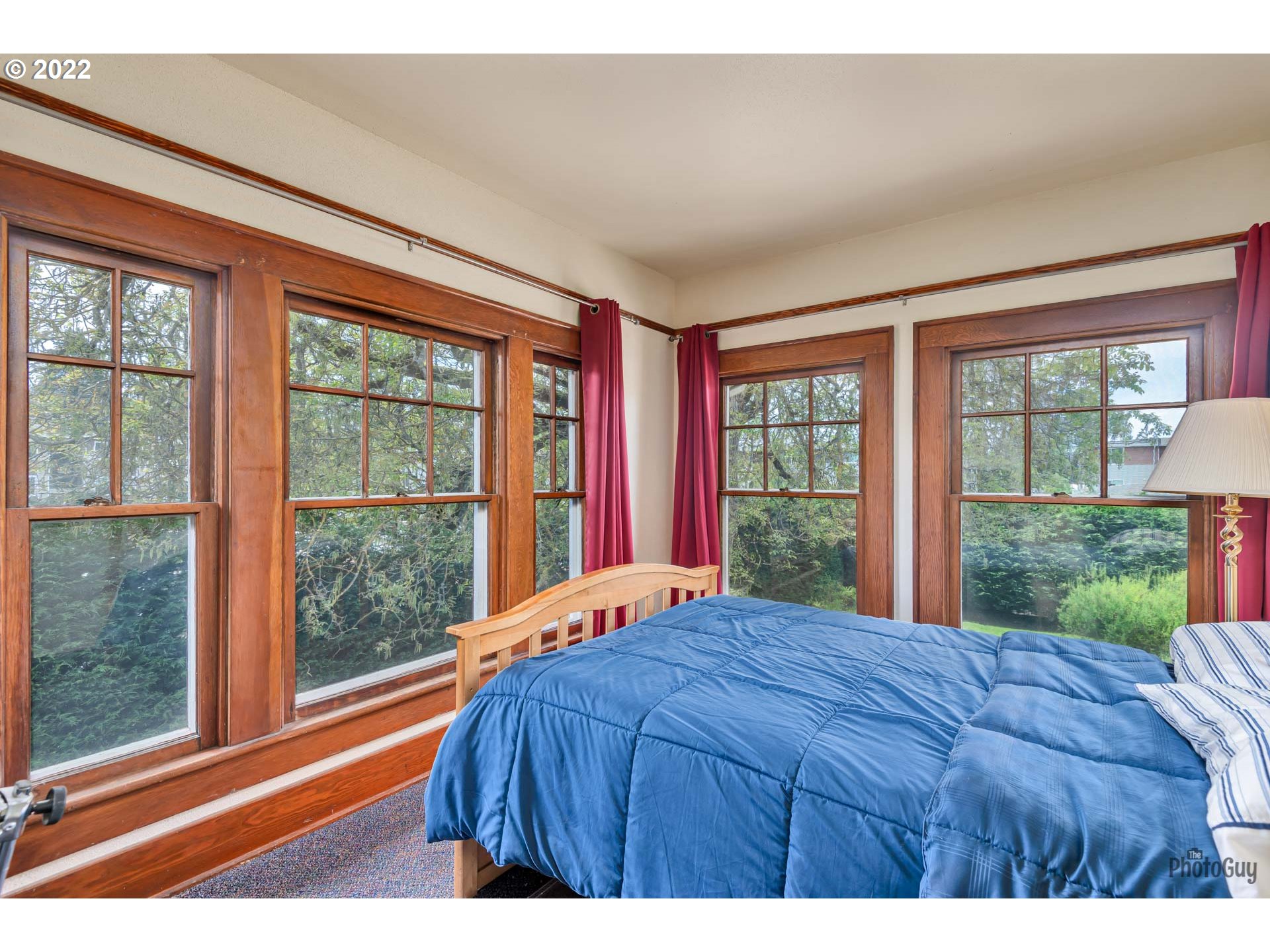 1410 River Road Eugene, OR 97404 - Photo 20 of 30 a bedroom with a bed and a large window