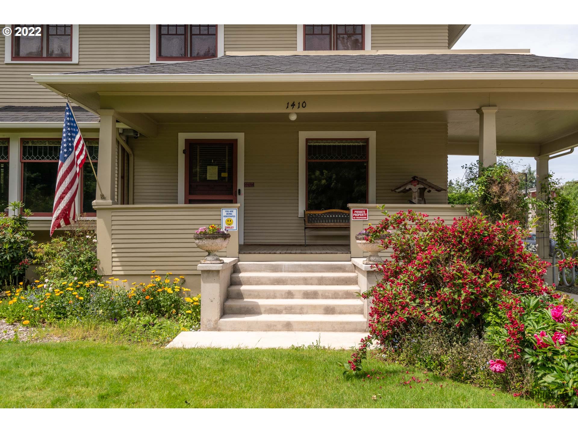 1410 River Road Eugene, OR 97404 - Photo 5 of 30 a view of a house with potted plants and a bench