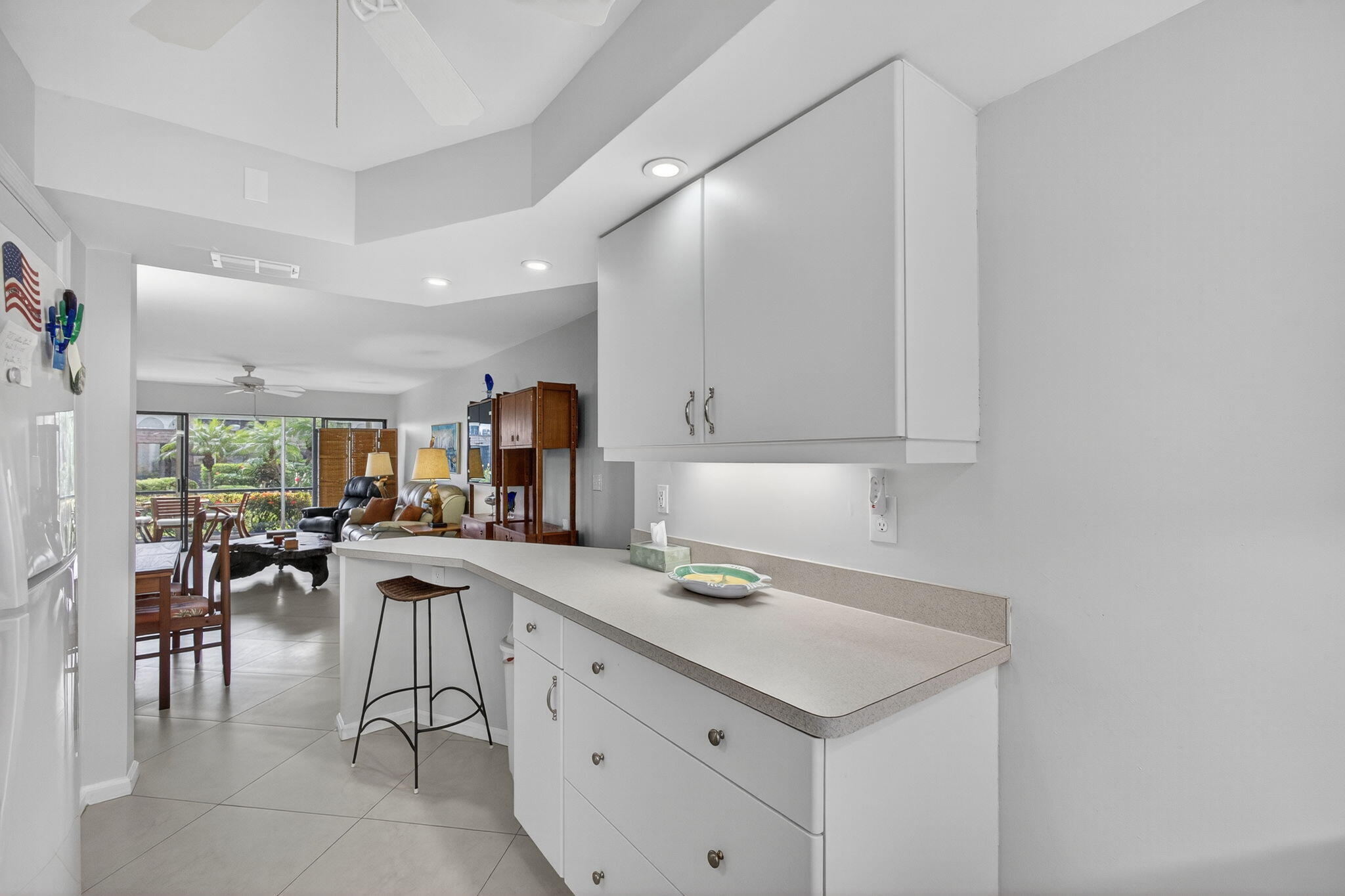 755 Saturn Street, Unit C105 Jupiter, FL 33477 - Photo 12 of 36 a kitchen with a sink cabinets and wooden floor