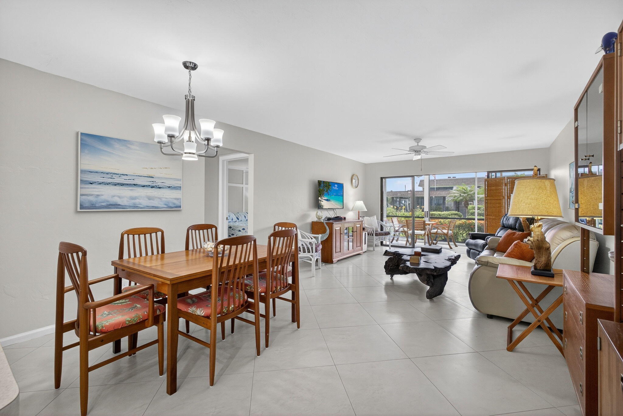 755 Saturn Street, Unit C105 Jupiter, FL 33477 - Photo 13 of 36 a view of a dining room with furniture a chandelier and wooden floor