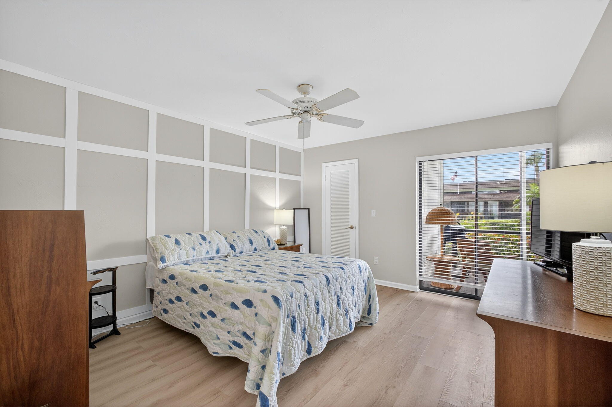 755 Saturn Street, Unit C105 Jupiter, FL 33477 - Photo 17 of 36 a bedroom with a bed and wooden floor