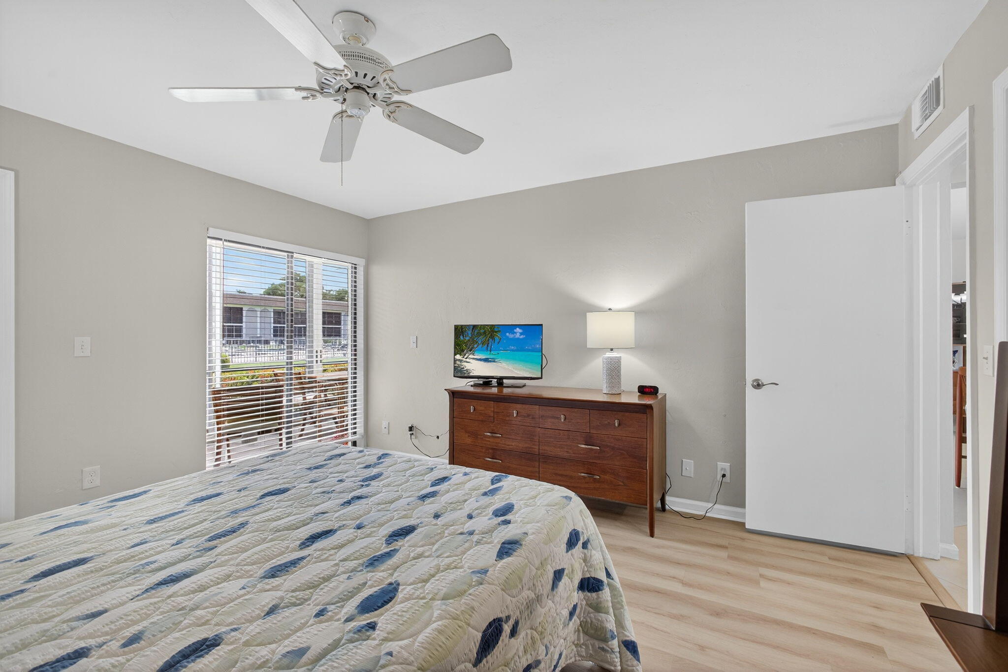 755 Saturn Street, Unit C105 Jupiter, FL 33477 - Photo 19 of 36 a bedroom with a bed and a dresser