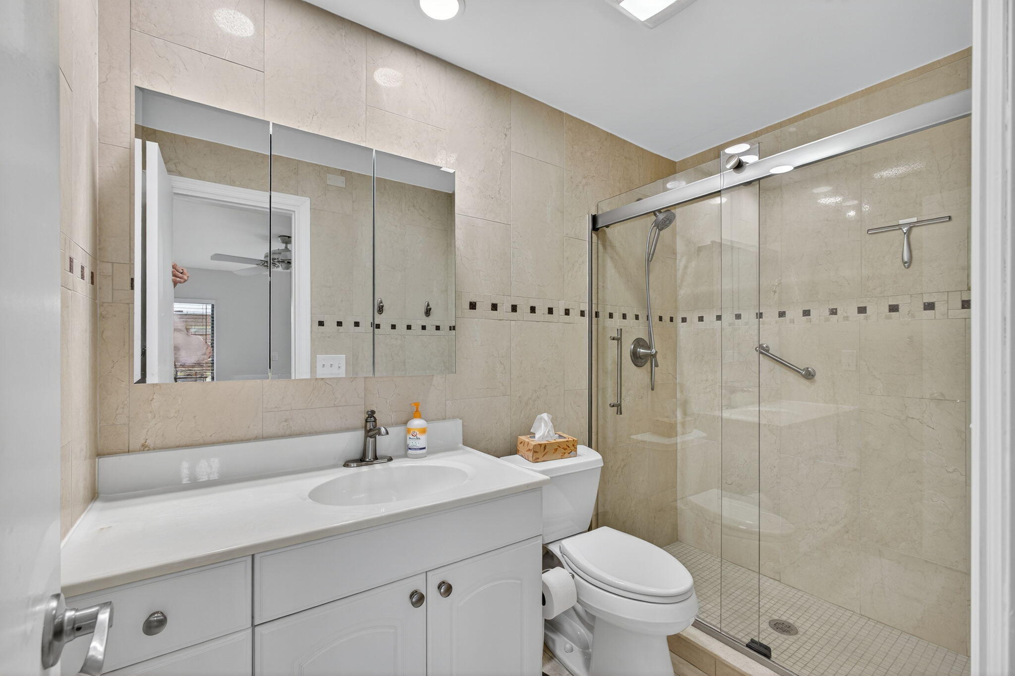 755 Saturn Street, Unit C105 Jupiter, FL 33477 - Photo 20 of 36 a bathroom with a sink a toilet and shower