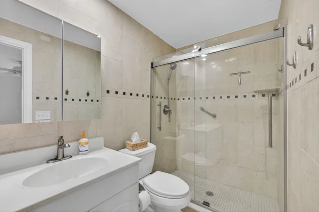 a bathroom with a toilet sink and mirror