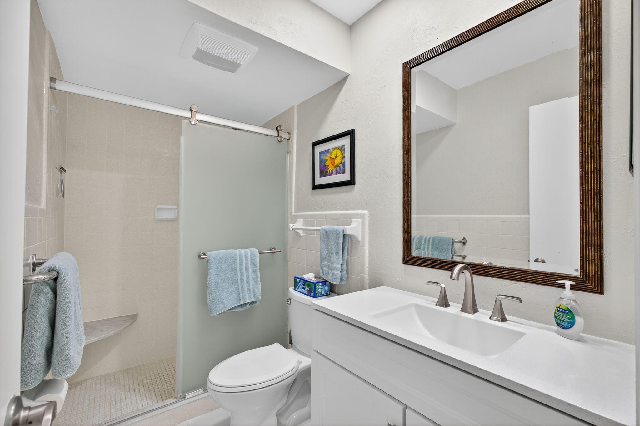 755 Saturn Street, Unit C105 Jupiter, FL 33477 - Photo 22 of 36 a bathroom with a sink toilet vanity and shower