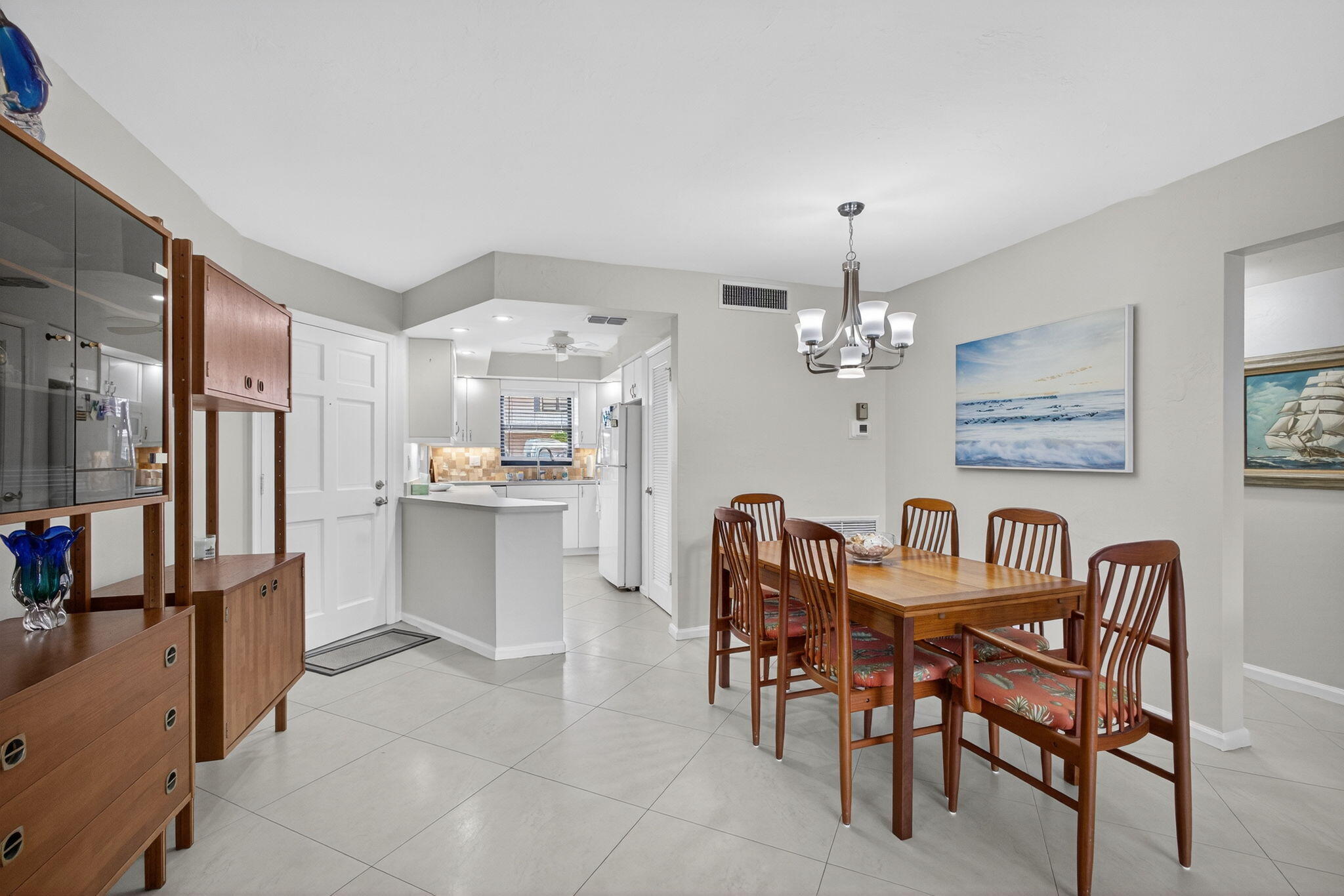 755 Saturn Street, Unit C105 Jupiter, FL 33477 - Photo 27 of 36 a view of a dining room with furniture