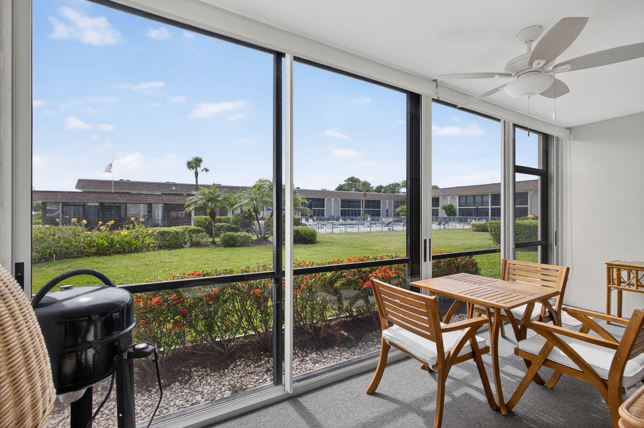 755 Saturn Street, Unit C105 Jupiter, FL 33477 - Photo 29 of 36 a view of a porch with furniture and a yard