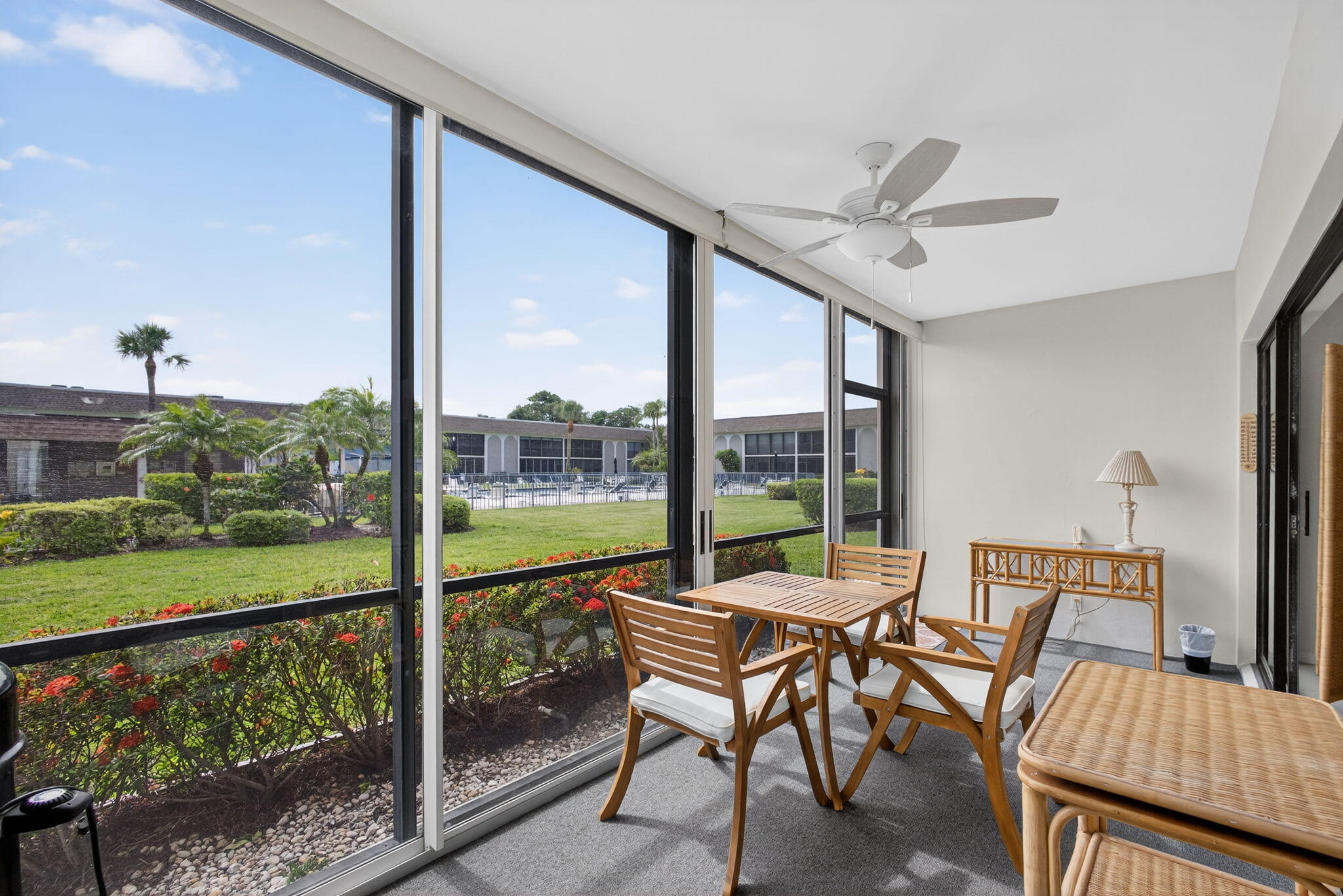 755 Saturn Street, Unit C105 Jupiter, FL 33477 - Photo 30 of 36 a living room with furniture and a floor to ceiling window