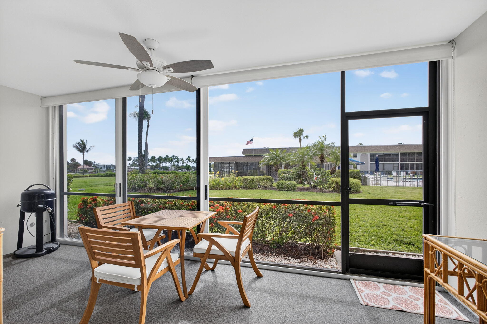 755 Saturn Street, Unit C105 Jupiter, FL 33477 - Photo 31 of 36 a view of a chairs and table in the patio