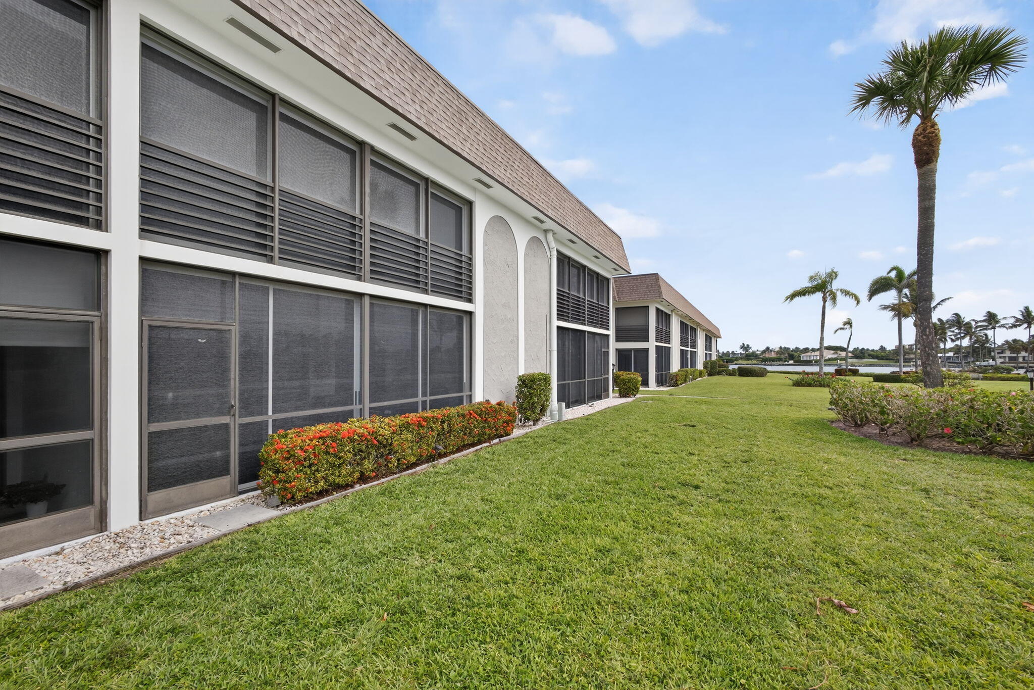 755 Saturn Street, Unit C105 Jupiter, FL 33477 - Photo 32 of 36 a view of house with backyard and garden