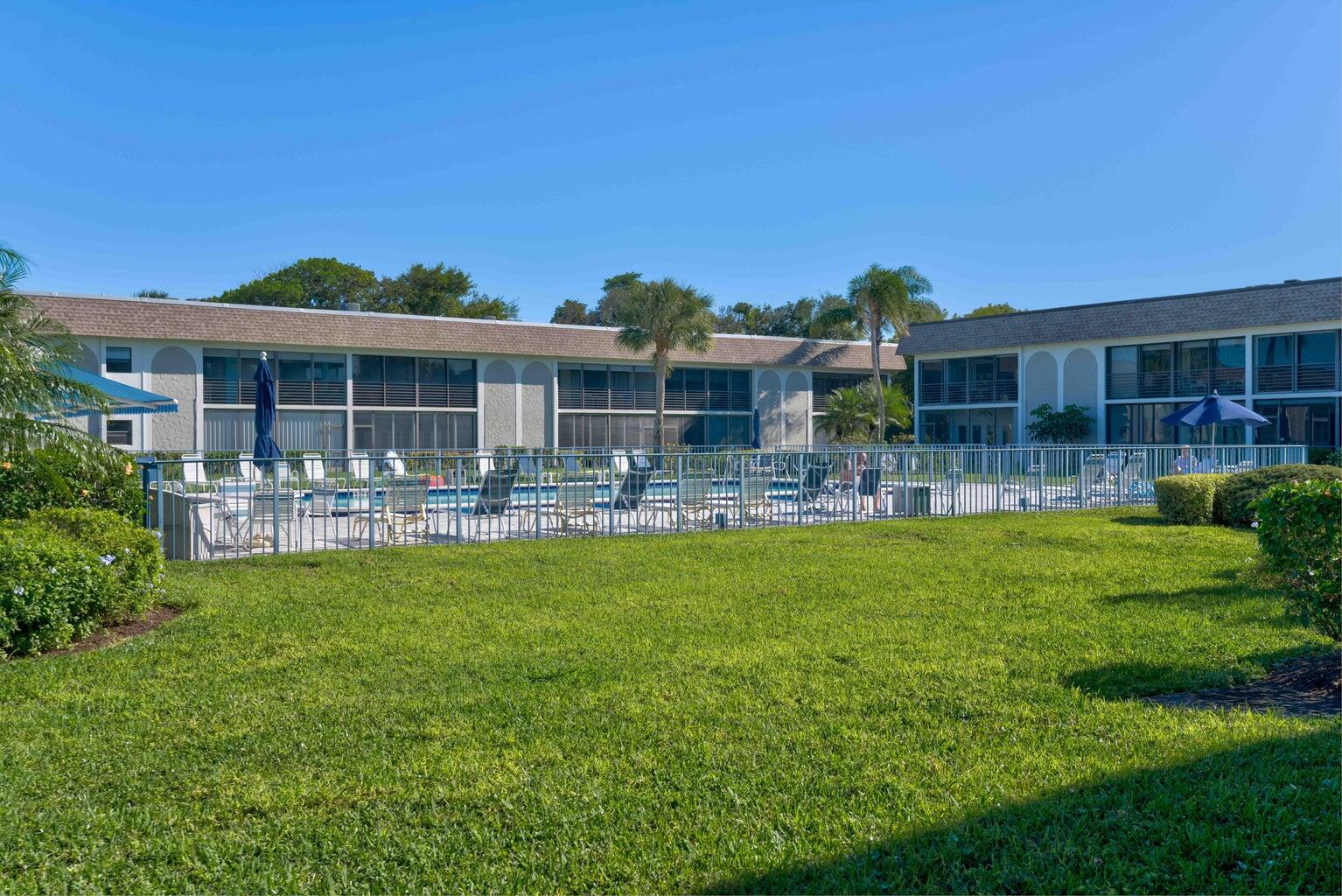 755 Saturn Street, Unit C105 Jupiter, FL 33477 - Photo 35 of 36 a front view of house with yard and outdoor seating