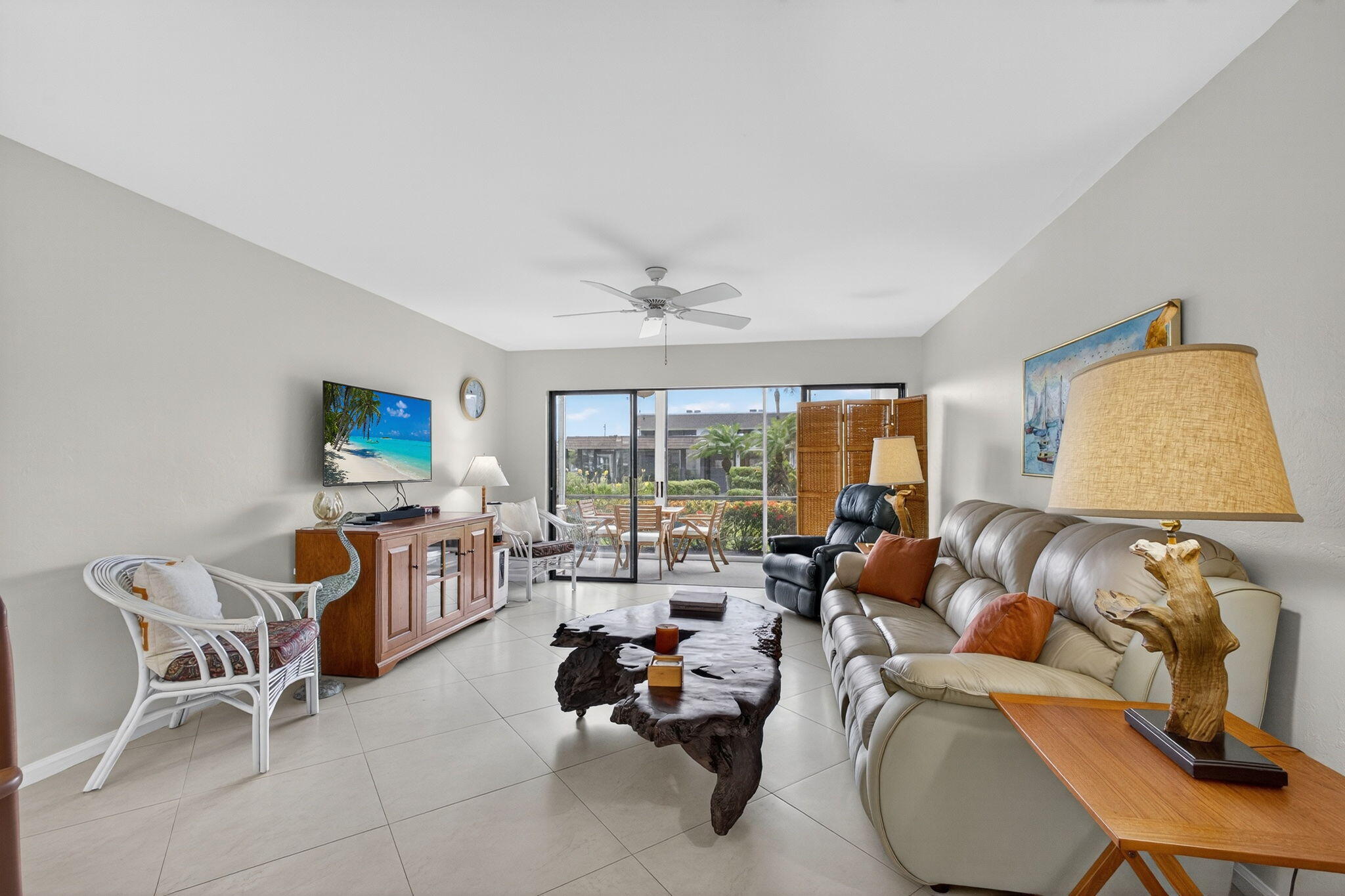 755 Saturn Street, Unit C105 Jupiter, FL 33477 - Photo 5 of 36 a living room with furniture and a flat screen tv