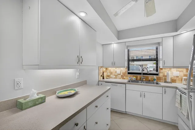 a white refrigerator freezer sitting inside of a kitchen