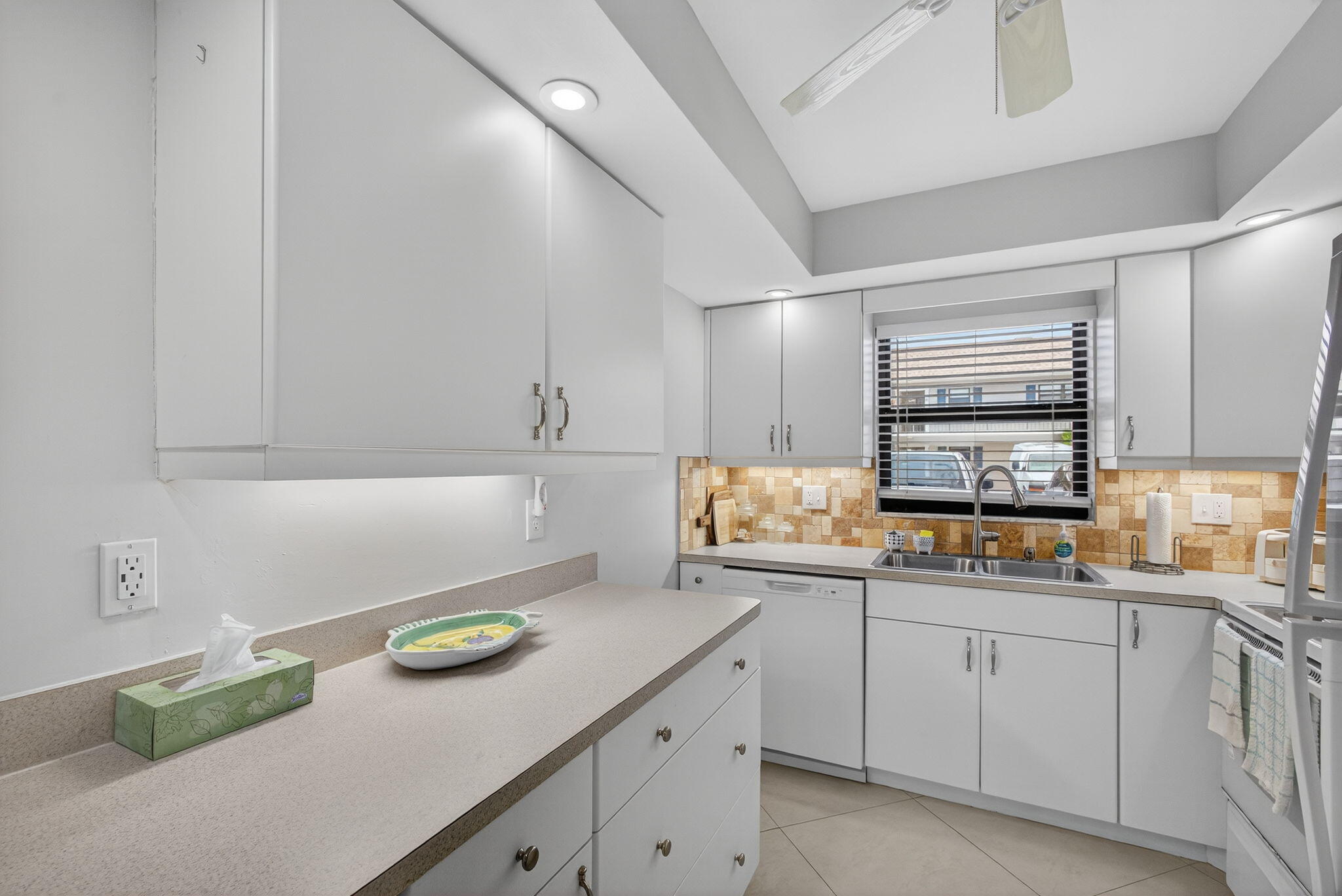 755 Saturn Street, Unit C105 Jupiter, FL 33477 - Photo 9 of 36 a kitchen with a sink and cabinets
