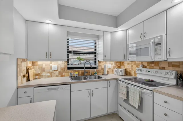 a kitchen with a sink cabinets and wooden floor