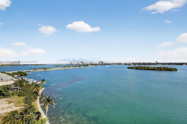 a bedroom with a bed and large window