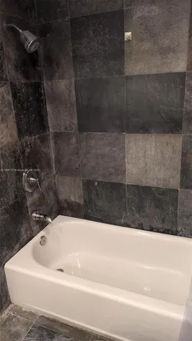 a kitchen with a refrigerator and a stove top oven