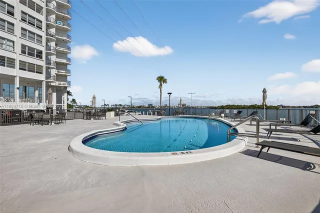 a view of a lake with a big yard and large trees
